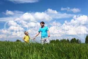 father with son in summer day outdoors