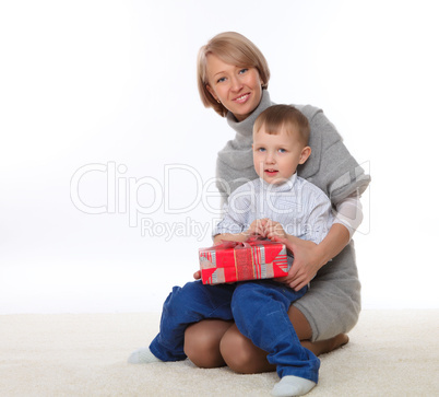mother and son holding a present