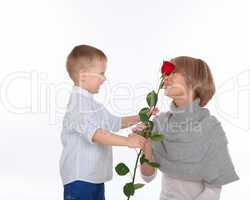 mother and son holding a red rose