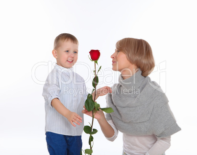 mother and son holding a red rose