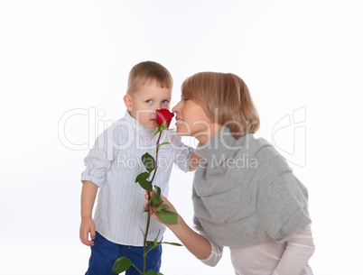 mother and son holding a red rose