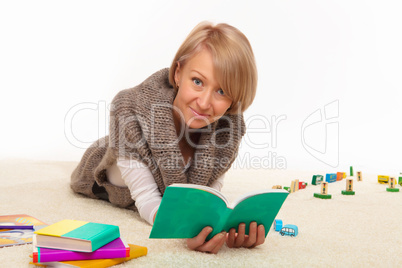 mother at home reading a book alone