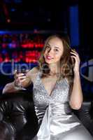 Young woman in night club with a drink