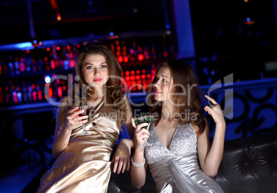 Young woman in night club with a drink