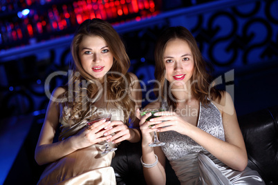 Young woman in night club with a drink