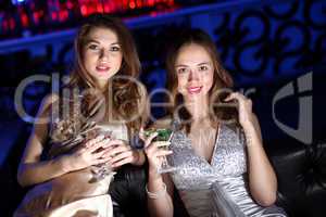 Young woman in night club with a drink