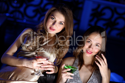 Young woman in night club with a drink