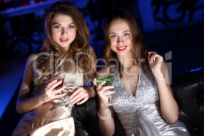 Young woman in night club with a drink