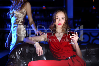 Young woman in night club with a drink