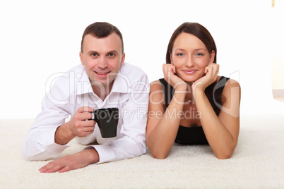 couple at home holding a mug