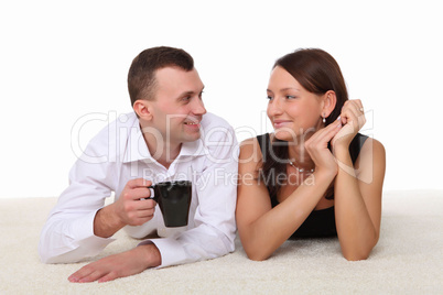 couple at home holding a mug