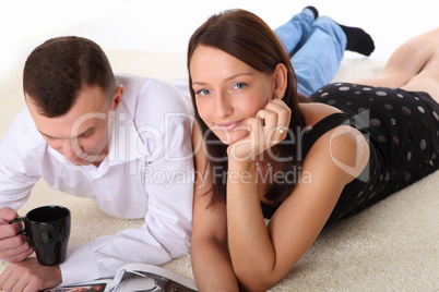 couple at home holding a mug