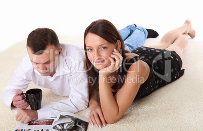 couple at home holding a mug