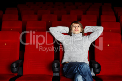 Young man in cinema watching movie