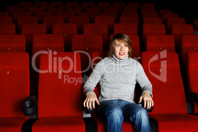 Young man in cinema watching movie