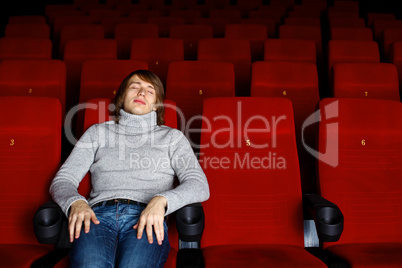 Young man in cinema watching movie