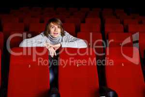 Young man in cinema watching movie