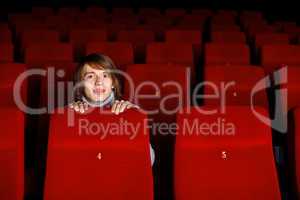 Young man in cinema watching movie