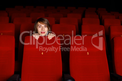 Young man in cinema watching movie