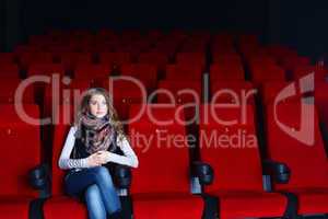 Young girl in cinema watching movie