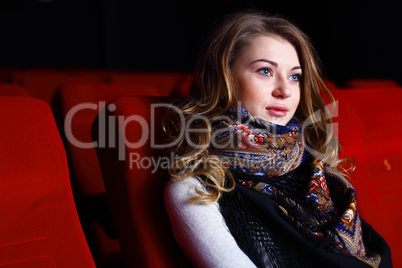 Young girl in cinema watching movie