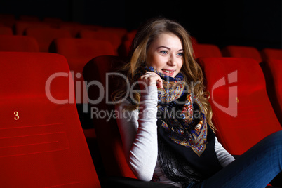 Young girl in cinema watching movie