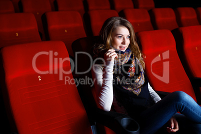 Young girl in cinema watching movie