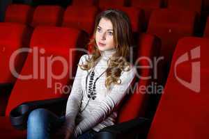 Young girl in cinema watching movie