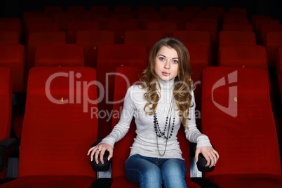 Young girl in cinema watching movie