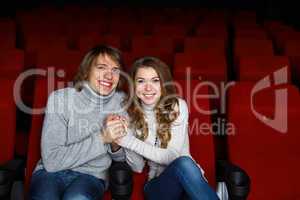 Young couple in cinema watching movie