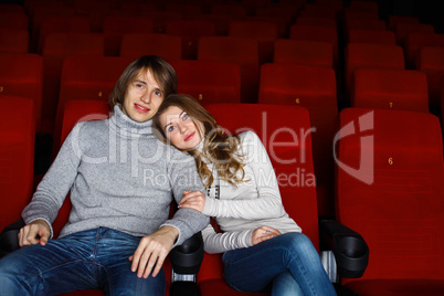 Young couple in cinema watching movie