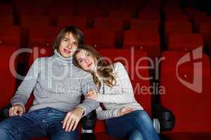 Young couple in cinema watching movie