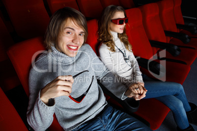 Young couple in cinema watching movie