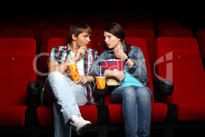 Young couple in cinema watching movie