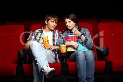 Young couple in cinema watching movie