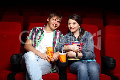 Young couple in cinema watching movie