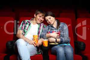 Young couple in cinema watching movie