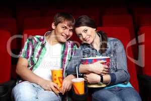 Young couple in cinema watching movie