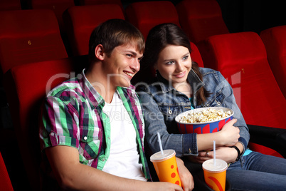 Young couple in cinema watching movie