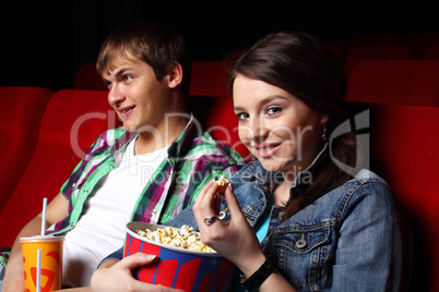 Young couple in cinema watching movie