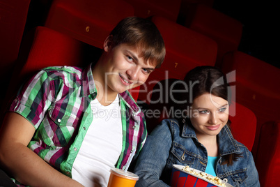 Young couple in cinema watching movie