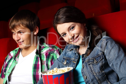 Young couple in cinema watching movie