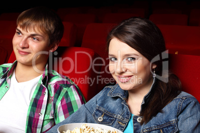 Young couple in cinema watching movie