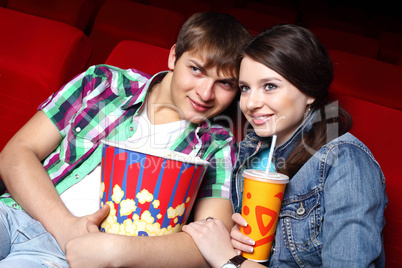 Young couple in cinema watching movie