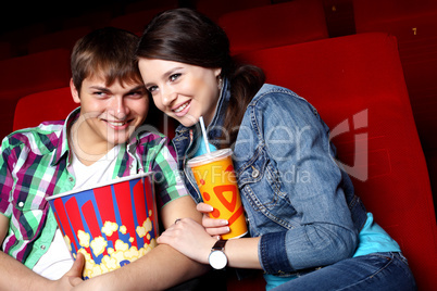 Young couple in cinema watching movie