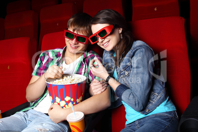 Young couple in cinema watching movie