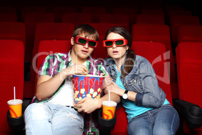 Young couple in cinema watching movie