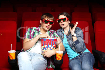 Young couple in cinema watching movie