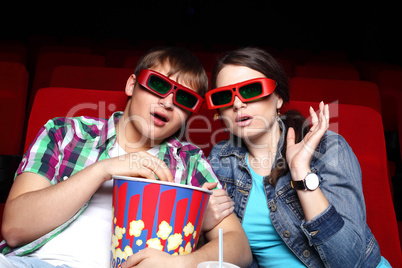 Young couple in cinema watching movie