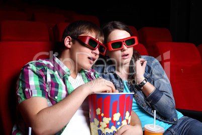 Young couple in cinema watching movie